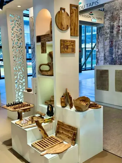 The ArtisRaw stand at Maison&Objet Paris 2026: olive wood boards, bowls, a chess set and serving pieces arranged on white plinths