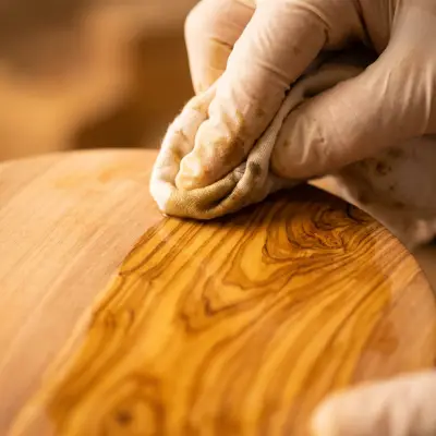 Mineral oil and beeswax finish being applied to olive wood