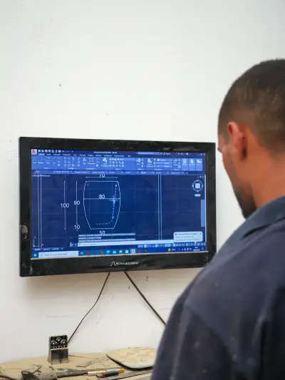 An ArtisRaw colleague reviewing a product drawing on screen against the order specification